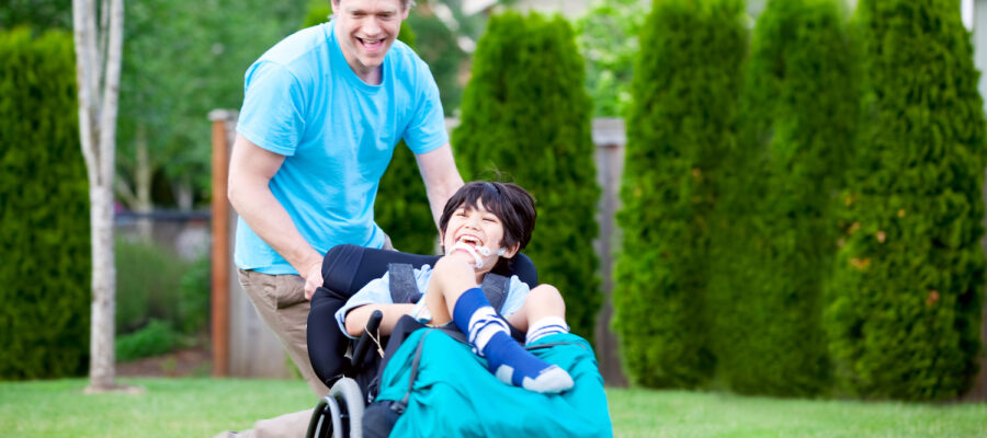 Father running with disabled son in wheelchair